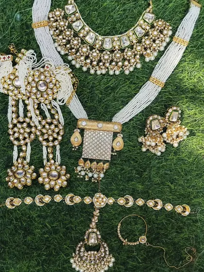 A royal-looking bridal set with a layered necklace, choker, and matching accessories including a passa and nath.