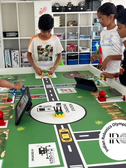 Our students are deep in preparation for the IRO 2024, working together around the challenge mat to test their robot's ability to complete farming-related tasks.