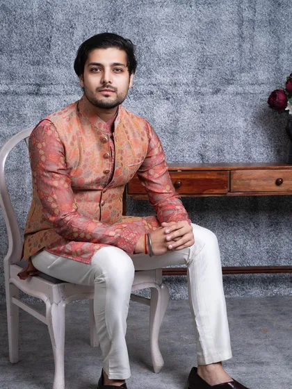 A seated portrait in our Versaverve bundi set. The rich color palette and harmonious pattern make it a sophisticated choice for an engagement or family gathering.