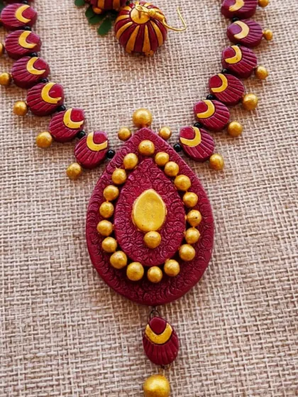 A close-up of the teardrop pendant, highlighting the detailed texture and the small hanging jhumka.