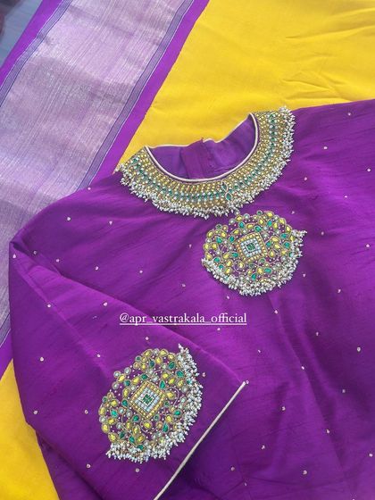 The neckline features a collar-like design with a central pendant motif.