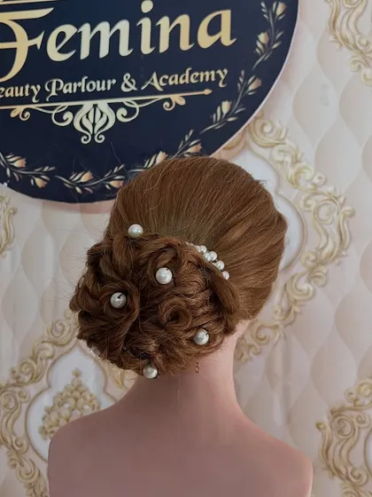 A textured, multi-layered bun with pearls scattered throughout. This style has a lot of detail and looks beautiful from all angles.