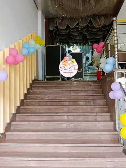 Simple balloon clusters decorating a staircase to lead guests to the party area.