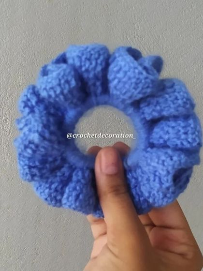 A close-up of the blue crochet scrunchie, showing the ruffles and texture. All our scrunchies are washable and made to last.