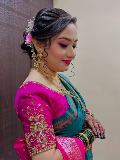 A side profile showing the soft curls and floral accessory in her hair.