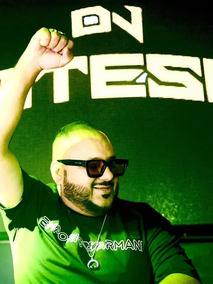 Fist pump in front of a green-lit screen with my name. The energy is always high, and the visuals match it.