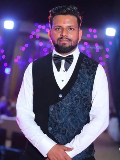 A close-up of our client, showcasing the detailed waistcoat and bow tie that complete his formal look.