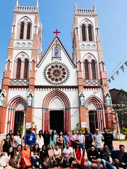 A large group photo in front of the beautiful Basilica of the Sacred Heart of Jesus in Pondicherry.