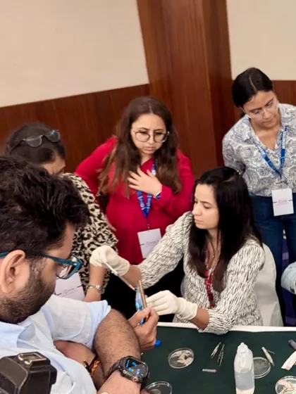 Here I am demonstrating a hands-on procedural technique during a Vitiligo workshop for other dermatologists. I believe that sharing knowledge is key to advancing our field, and I am passionate about teaching the practical skills required for successful Vitiligo surgery, including suspension preparation and grafting.