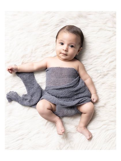 This simple, minimalist portrait of a 3-month-old on a fluffy white rug keeps all the focus on the baby's sweet expression and tiny features.