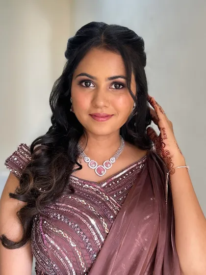 A beautiful client ready for a party. Her makeup is soft and glamorous, with a focus on her eyes.
