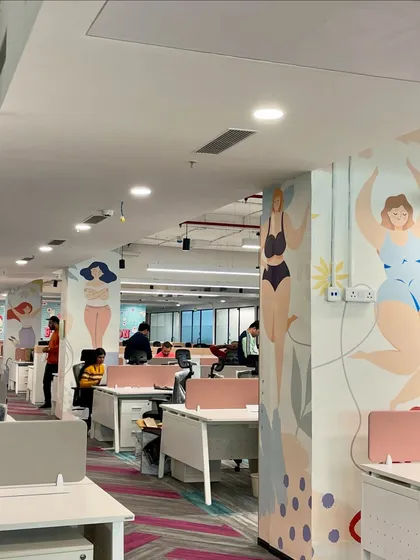 This wall mural at the Clovia office celebrates body positivity with joyful, colorful illustrations of women, infusing the workspace with the brand's core values.