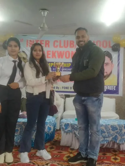 Receiving an award for the academy's performance at the Inter-Club championship. Our team's collective effort is always recognized.