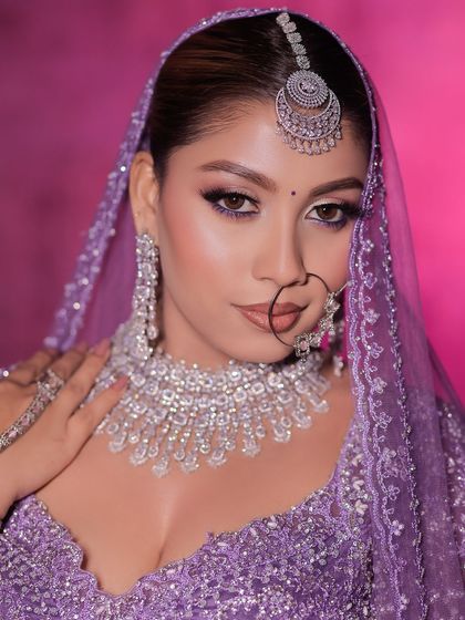 A modern bridal look featuring a lavender lehenga paired with a stunning diamond and silver jewellery set. This shows how you can rent contemporary jewellery for a unique look.