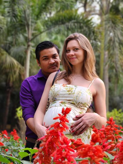 Posing with my husband during our pregnancy photoshoot. Sharing this journey with a supportive partner makes all the difference.