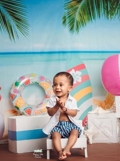 Life's a beach. We bring the seaside to the studio with this fun beach theme, complete with a sandy shore, beach balls, and flamingos.