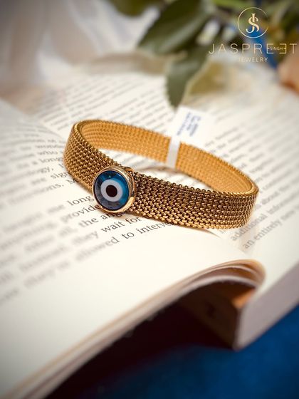 A closer look at one of my Evil Eye bracelets. This design features the protective symbol on a wide, textured gold-plated mesh band, offering a bold and fashionable way to wear your belief.