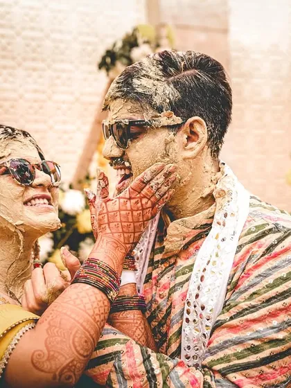 The Haldi ceremony is all about unrestrained joy, and we live for capturing it. This moment of the couple playfully smearing turmeric on each other, with genuine laughter and cool sunglasses, perfectly shows the fun and candid spirit we aim to freeze in time.