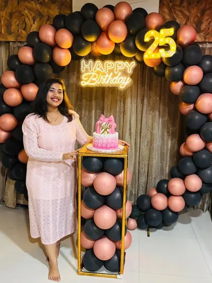 The birthday girl posing with her "Hello 25" cake. It's wonderful to see the final setup and the happy client.