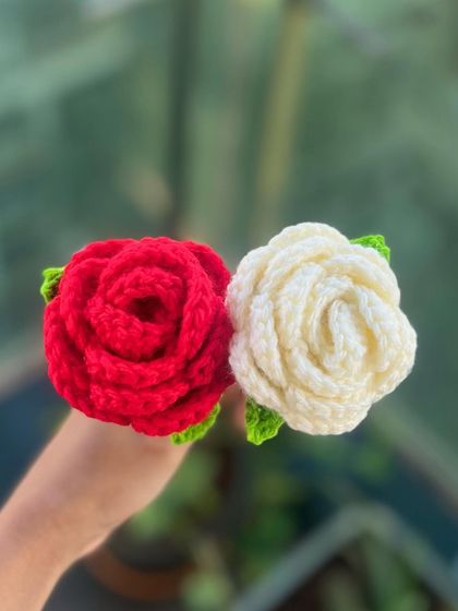A top-down view of my classic red and white crochet roses. Each petal is individually stitched to create the full, layered look of a real rose that you can keep forever.