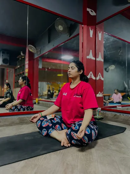 'Sthirasukham asanam'. The pose should be steady and comfortable. A student finds her peaceful seat in meditation.