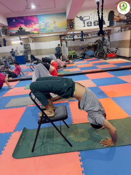 Another example of a supported backbend, this time with the head on the mat. This variation of Chakrasana (Wheel Pose) is great for building confidence and strength for the full pose.