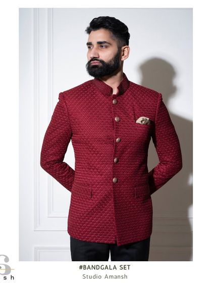 Our crimson bandhgala, styled with a pocket square for a touch of classic elegance. This piece is a perfect example of how we blend traditional silhouettes with bold, modern fabrics.