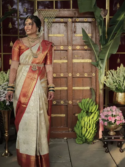 A full-length view of the bride in her stunning South Indian attire. The makeup is kept elegant and classic to match the grandeur of the occasion.