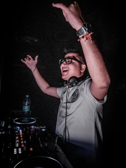 Hands up in celebration. That moment when a track hits perfectly and the whole room erupts.