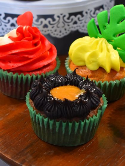 A trio of tempting cupcakes made by my students: rich Caramel Chocolate, classic Red Velvet, and tropical Pineapple.