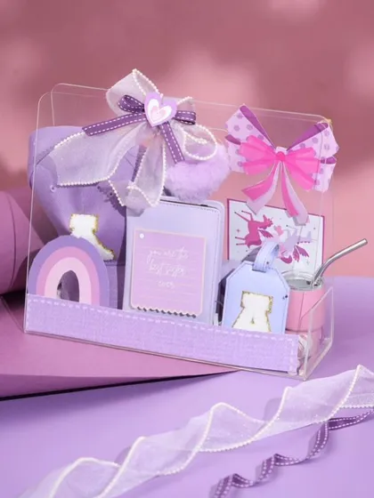 Our 'Princess Treatment' hamper in a lovely shade of purple. This box is filled with personalized items like a cap, a luggage tag, and other cute accessories for a little sister.