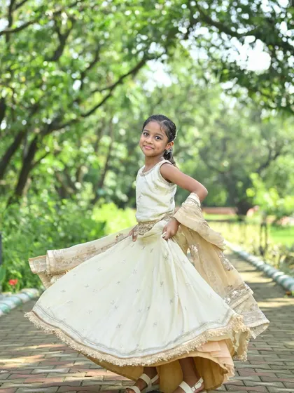 Custom festive wear isn't just for adults. This adorable ivory lehenga for kids is lightweight and perfect for little ones to twirl and play in during celebrations, complete with a matching sequined dupatta.