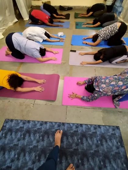 From my perspective as a teacher, this is a view of my class in Balasana, or Child's Pose. This resting posture is a reminder that the goal is serenity and finding peace in our own bodies.