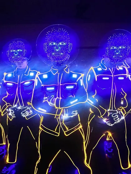A powerful shot of our Hologram Heads performance in Chennai. The dancers' faces are replaced with glowing, grid-like digital masks that pulse with blue light.