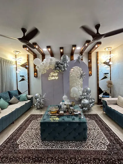 An elegant silver and white balloon decoration with arched backdrops, designed to complement the modern interior of this home.