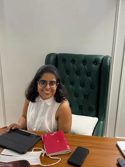A smiling portrait at my desk. Despite the deadlines and drafts, I genuinely love the work I do.
