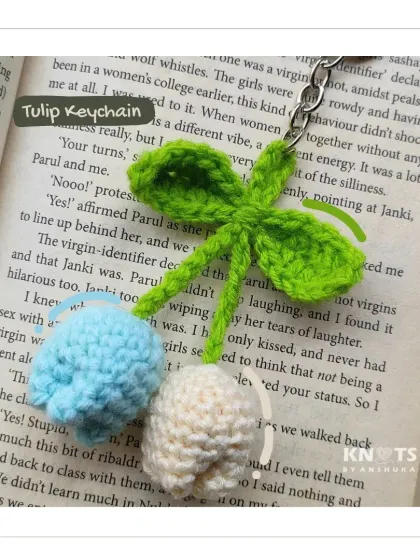 A simple and sweet crochet tulip keychain. This one features two little tulip buds, one blue and one white, on a leafy green stem.