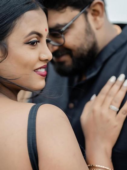 This shot highlights the elegant braided hairstyle and the clean lines of the makeup from the side.