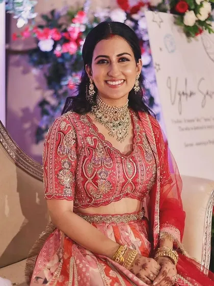 A close-up portrait of Shivani. Her makeup is fresh and modern, perfect for a contemporary family celebration.