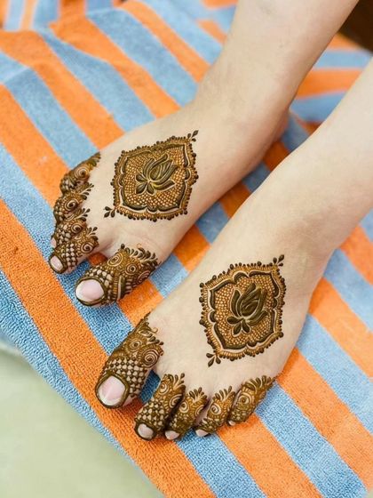 A lovely and simple lotus motif for the feet. The central pattern is framed beautifully, and the toes are decorated with intricate details, creating a clean and elegant look.