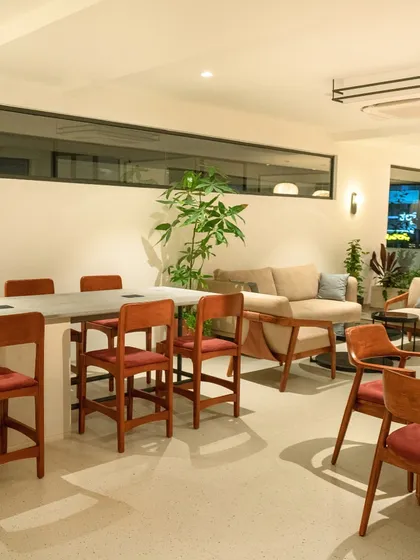 The color of calm. Our Whitefield cafe features a mix of comfortable seating, from a large communal table to cozy sofas, all in a soothing, neutral palette.