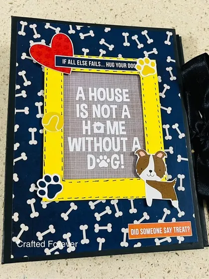 A house is not a home without a dog, and we love creating memory books for our furry family members. This is the cover of a dog-themed scrapbook, designed with fun patterns and a spot for a favorite photo, because their stories deserve to be told too.
