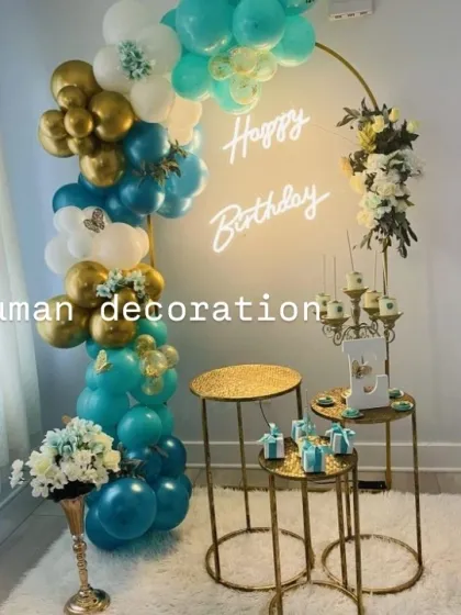 A teal, white, and gold birthday theme with a half-balloon arch. I also added artificial flowers and butterfly accents for a delicate touch.