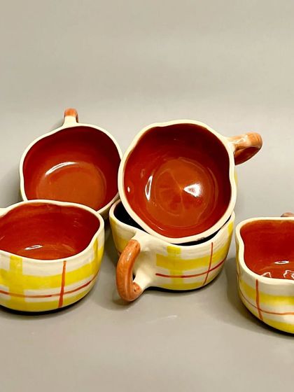 A set of my yellow plaid mugs. Each one is made with love and care, perfect for sipping your favorite brew in style and adding handmade beauty to your day.