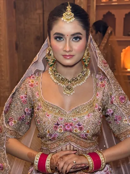 My philosophy is "less makeup, more you". For this bride's pastel lehenga, I created a soft glam look with a dewy finish, rosy cheeks, and natural-looking makeup that enhances her features without feeling heavy.