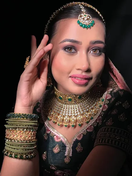 A portrait showcasing the beautiful contrast between the emerald green jewelry and the soft, romantic makeup.