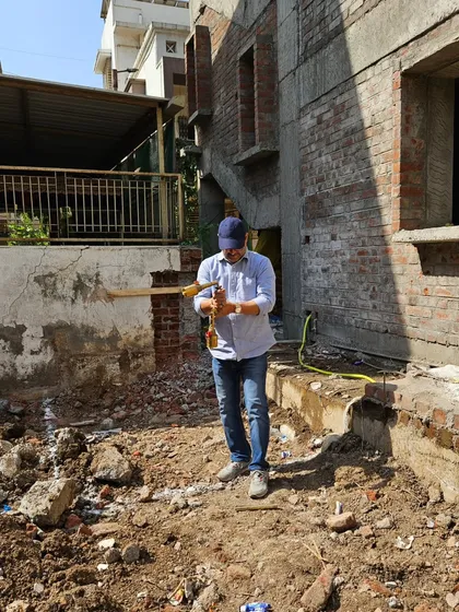 Taking precise measurements with my scanner at a construction site. This data is essential for creating my handmade, accurate Vastu reports.