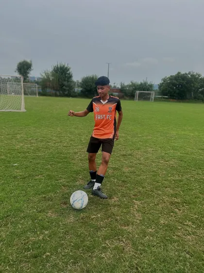 A player practicing ball control on the open pitch. Every touch is a chance to improve.