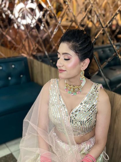 A side profile showing the soft eyeshadow and glowing highlighter that gives this look its fresh and youthful feel.