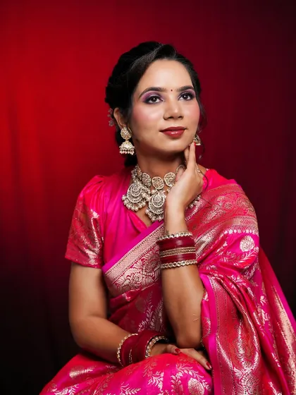 A graceful portrait of the model in her pink silk saree, her makeup looking radiant and fresh.